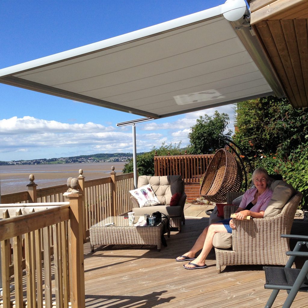 Customer sitting under her Markilux Pergola 110 in Cumbria